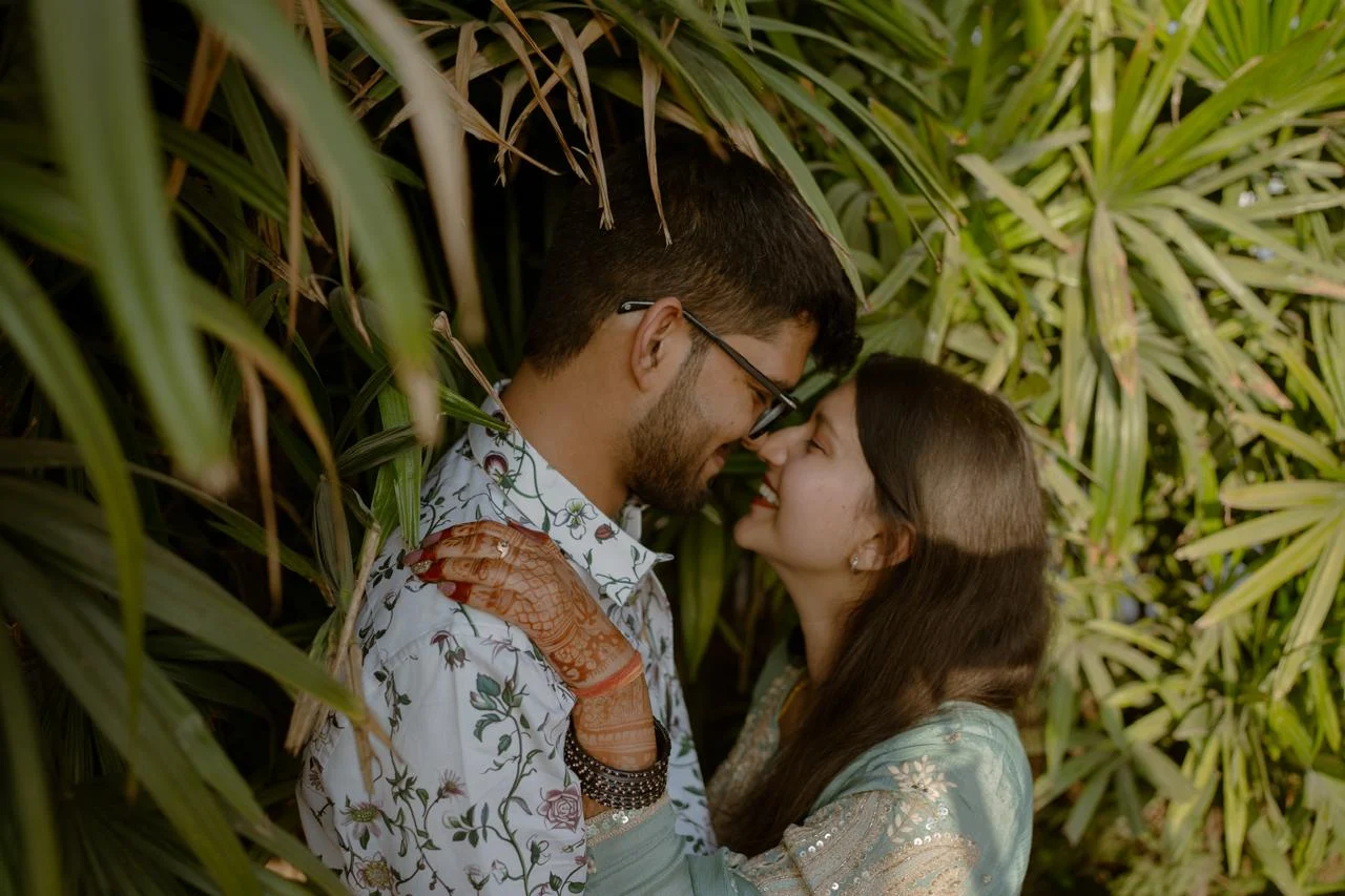Couple close portrait framed by tropical greenery