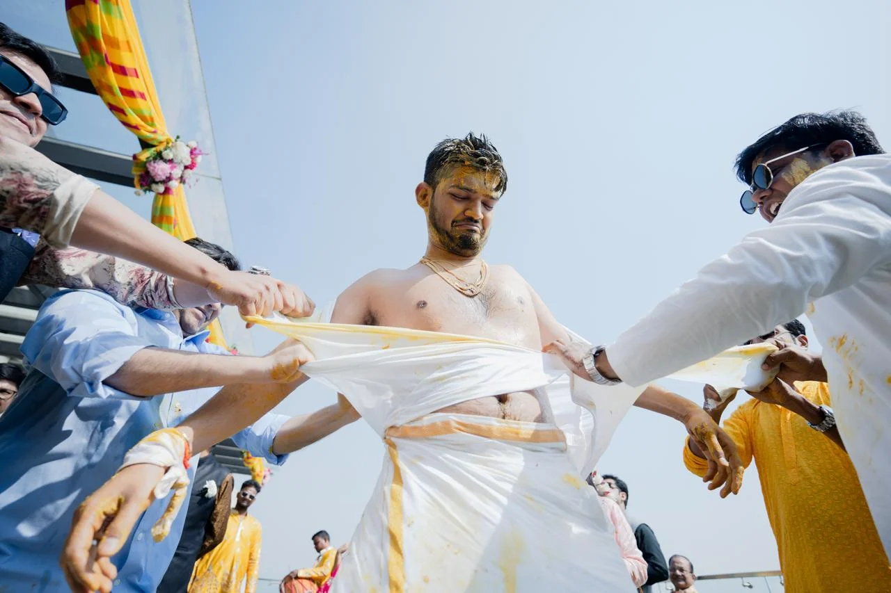 Traditional groom ritual during a lively haldi event